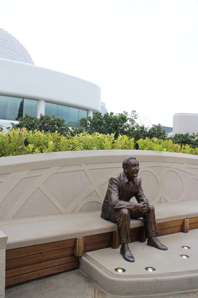 The Spaceship Earth lounge behind a bronze Walt Disney statue that sits in Epcot.