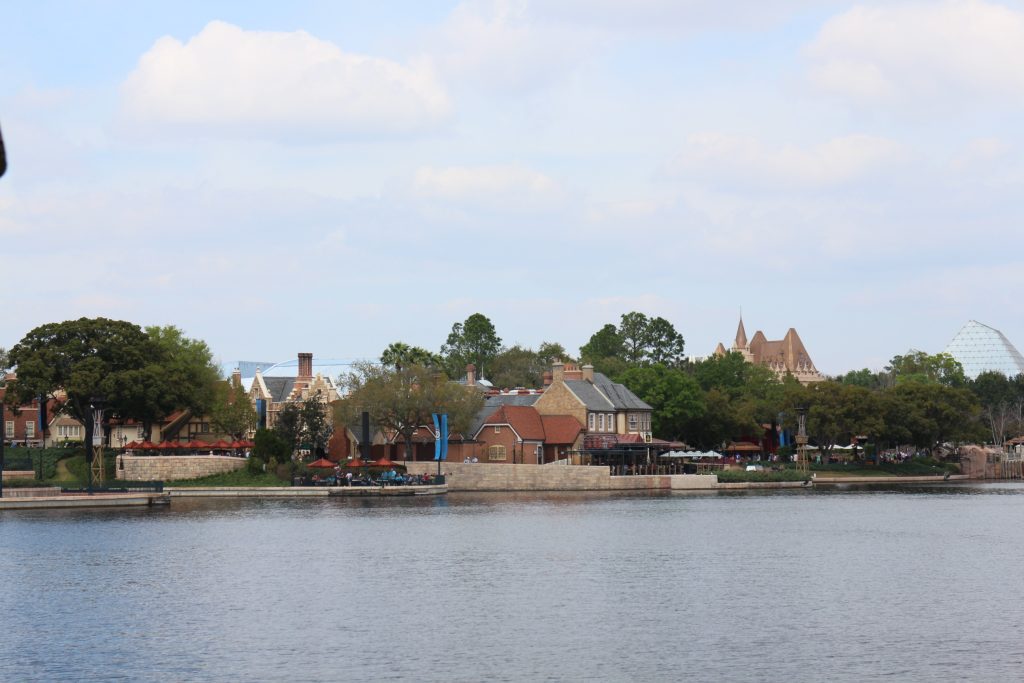 Outdoor quick service restaurant seating on the water in the United Kingdom Pavilion at Epcot.