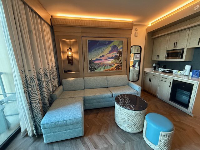 Inside the Polynesian Duo Studio at Disney you'll find a living room with a pulldown couch that converts to a bed.