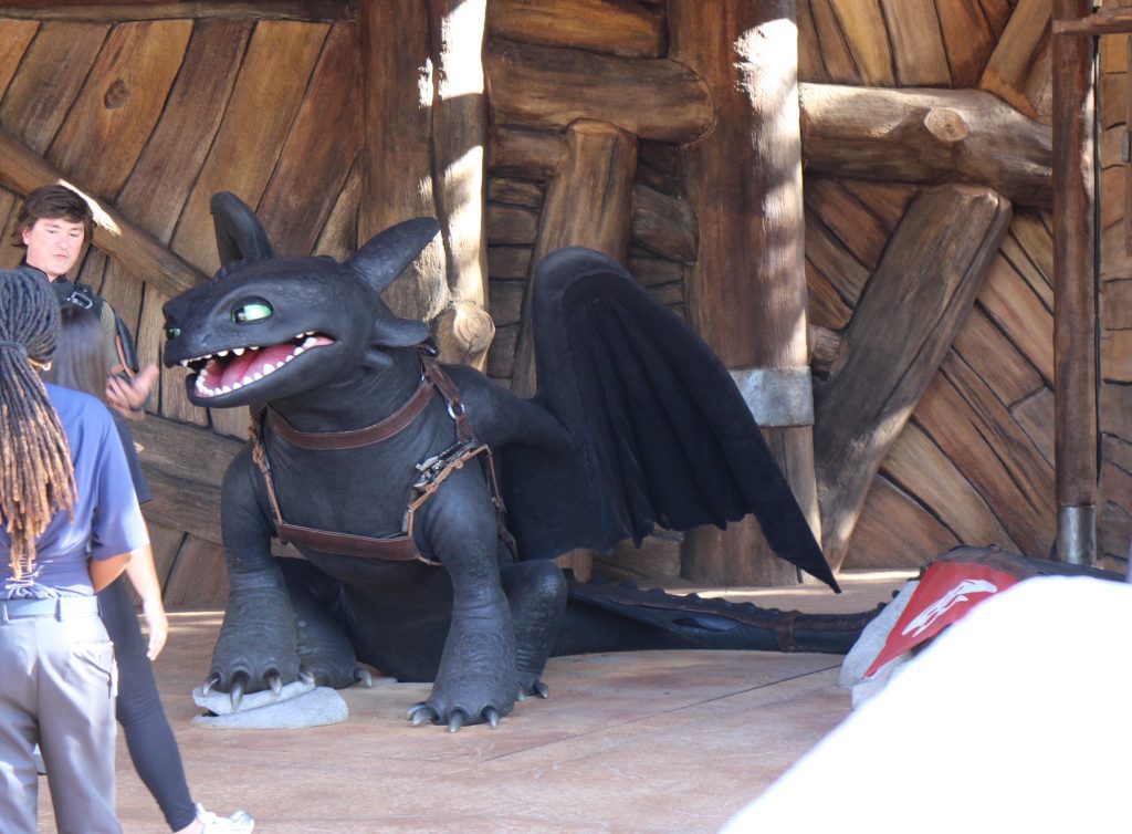 A black dragon and a viking at Epic Universe. The Toothless and Hiccup outdoor meet and greet.