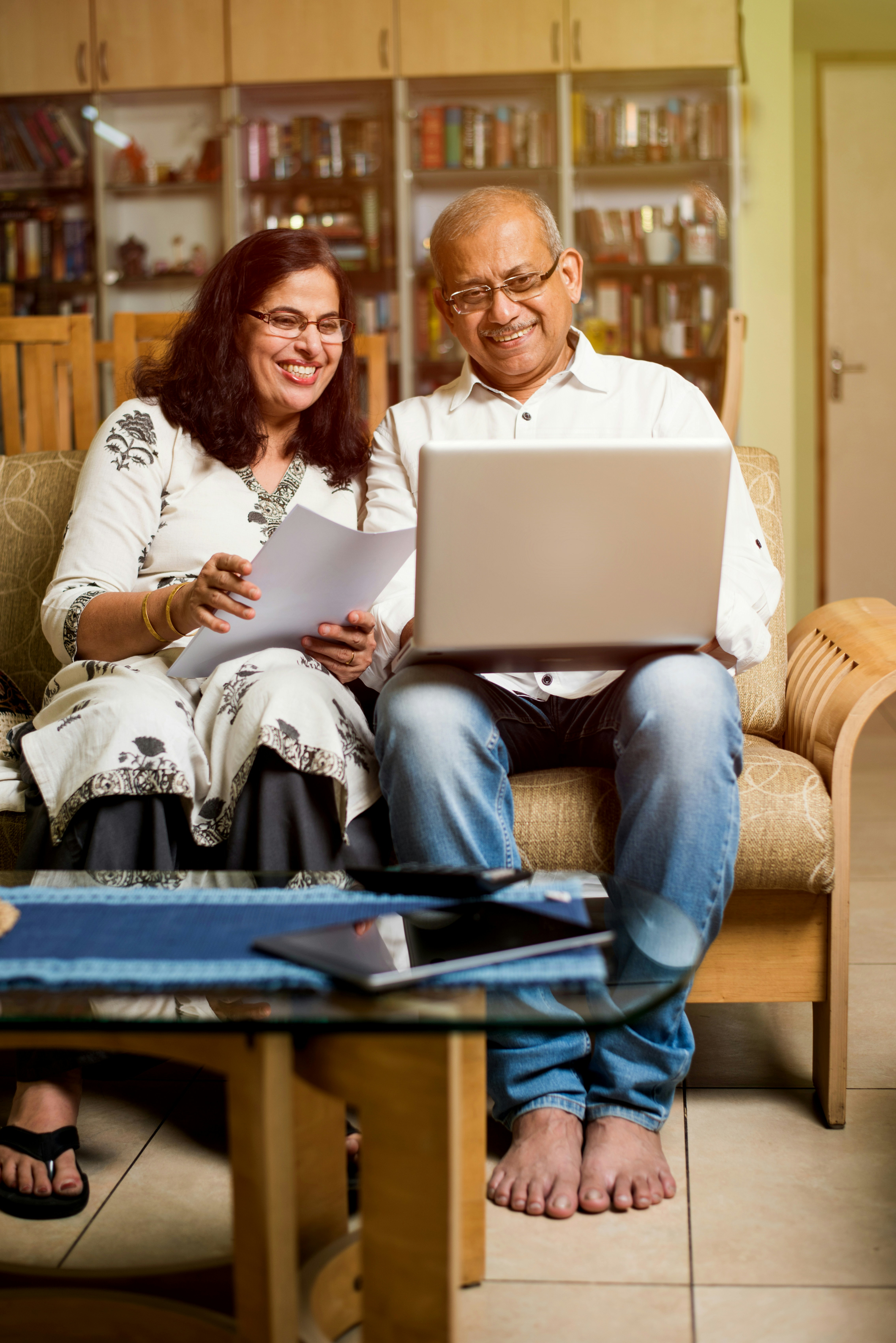 A couple reviewing documents together on a laptop
