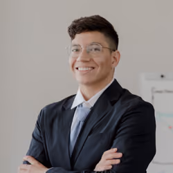 Portrait of a smiling man with glasses in a dark suit