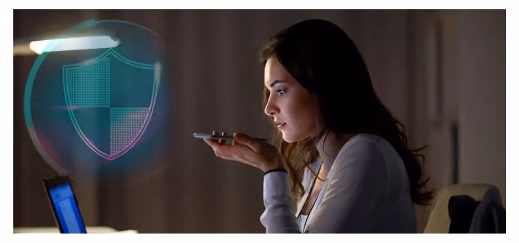 Woman speaking into a phone beside a glowing security shield hologram