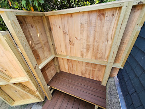 Clear cedar outdoor shower with built-in bench and natural cedar walls in Portsmouth, Rhode Island by Toensing Construction