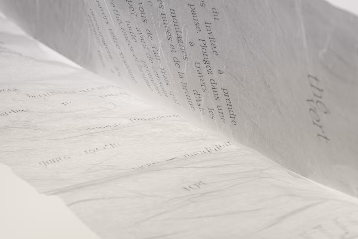 Macro shot of the two weights of Unryu Japanese paper packaging with a narrative story printed on them.