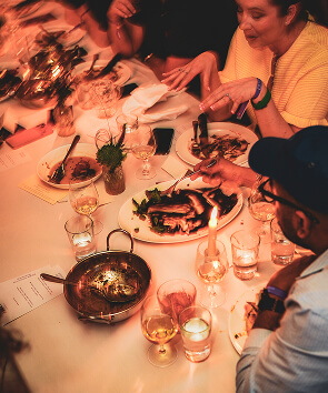 people sitting around dining table in evening