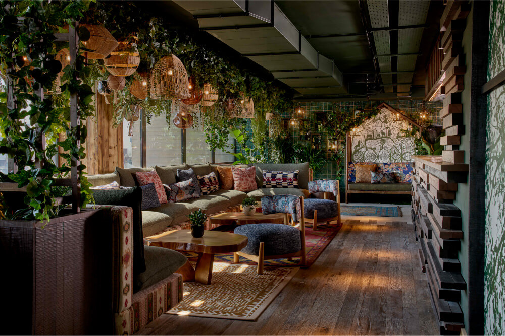 sister moon dining room with green plants and colorful seating
