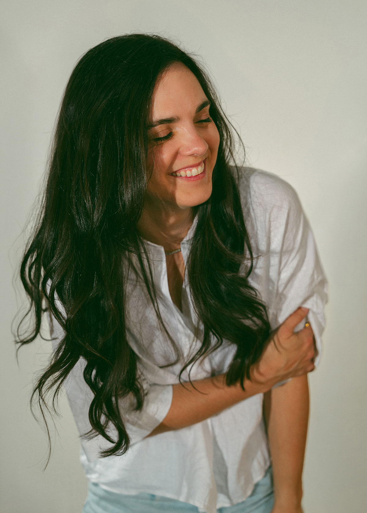 Joannie Rosa en chemise blanche, souriante