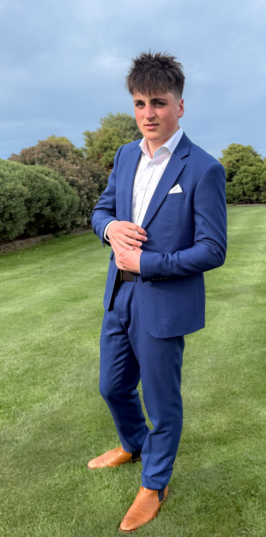 Quinn in a suit looking at the camera