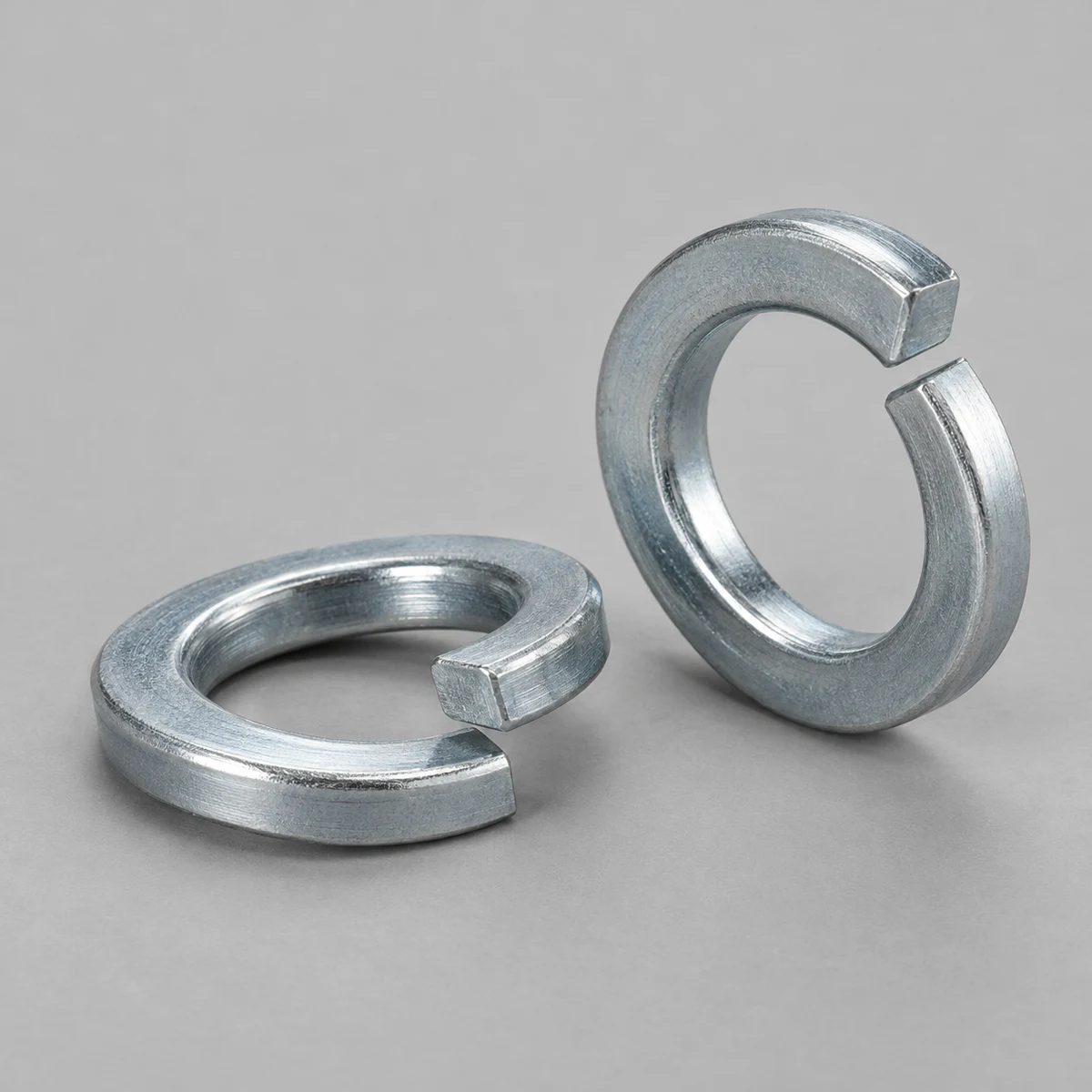 Spring Washer - DIN 127 family, steel, zinc plated, helical split and offset ends (product illustration)