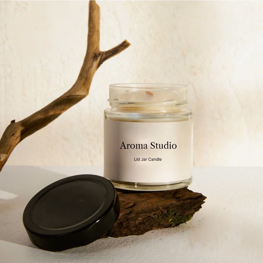 Aroma Studio candle in a cozy styled setting