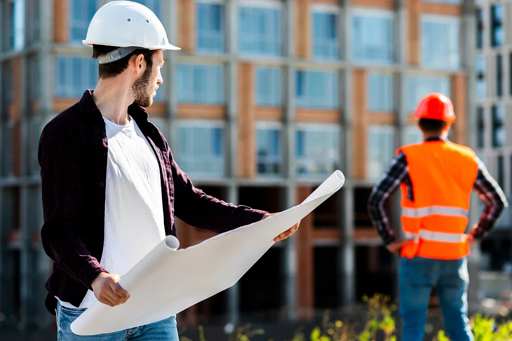 Stavbyvedoucí s projektovou dokumentací na staveništi