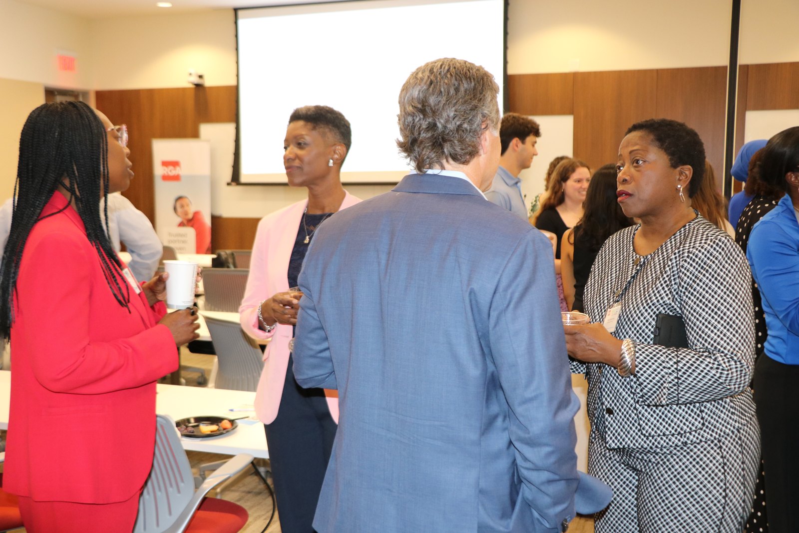Diverse group of professionals networking at SMPHR social event with drinks