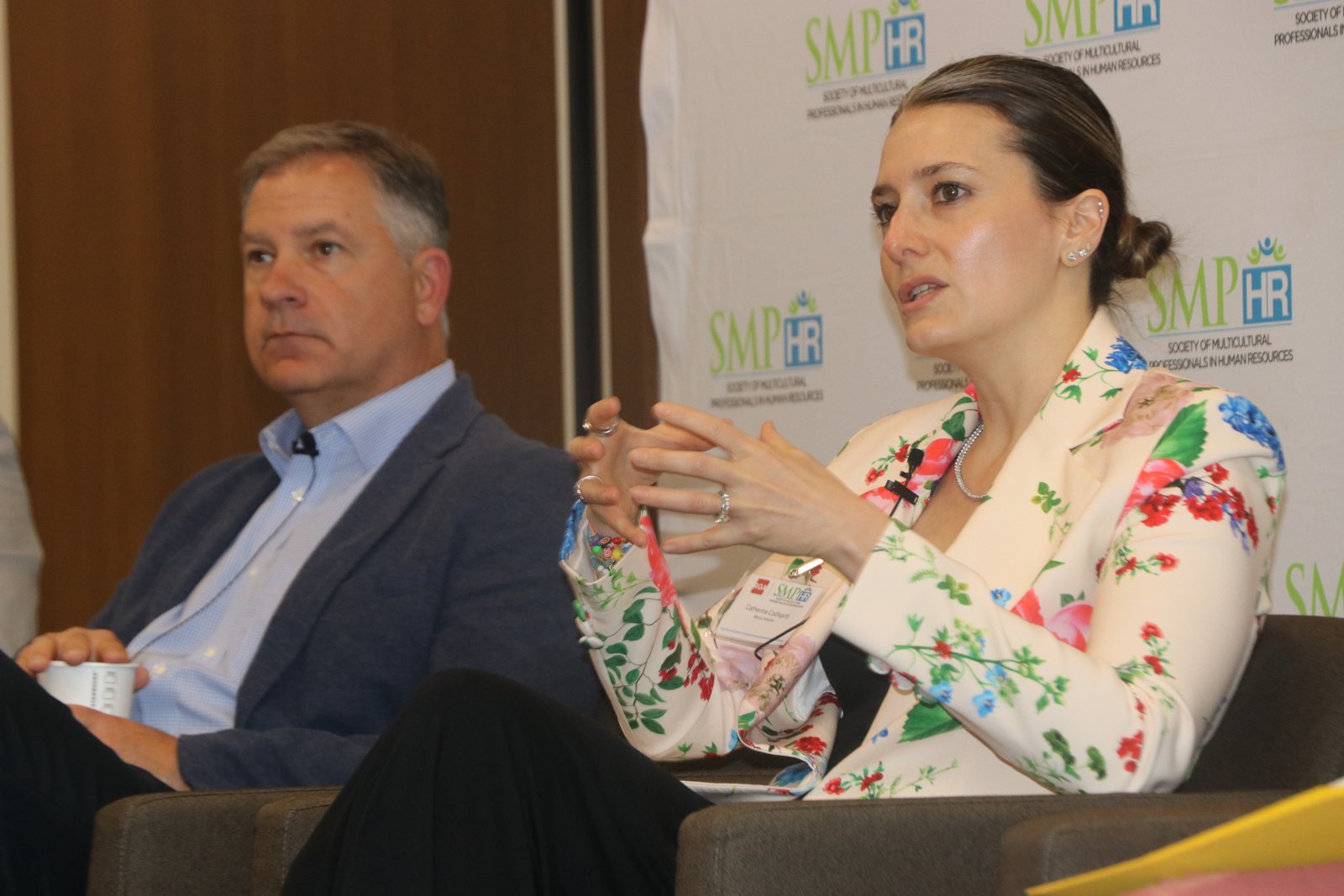 Man and woman panelists engaged in discussion at SMPHR event