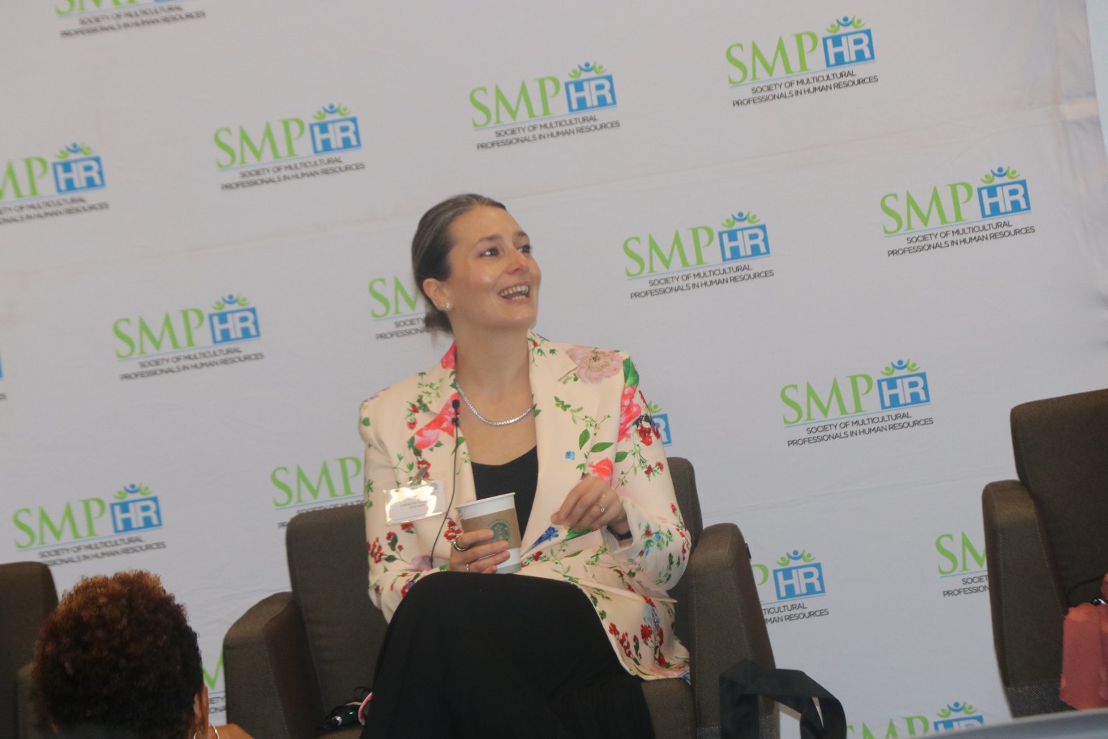 Woman professional speaker in profile at SMPHR event