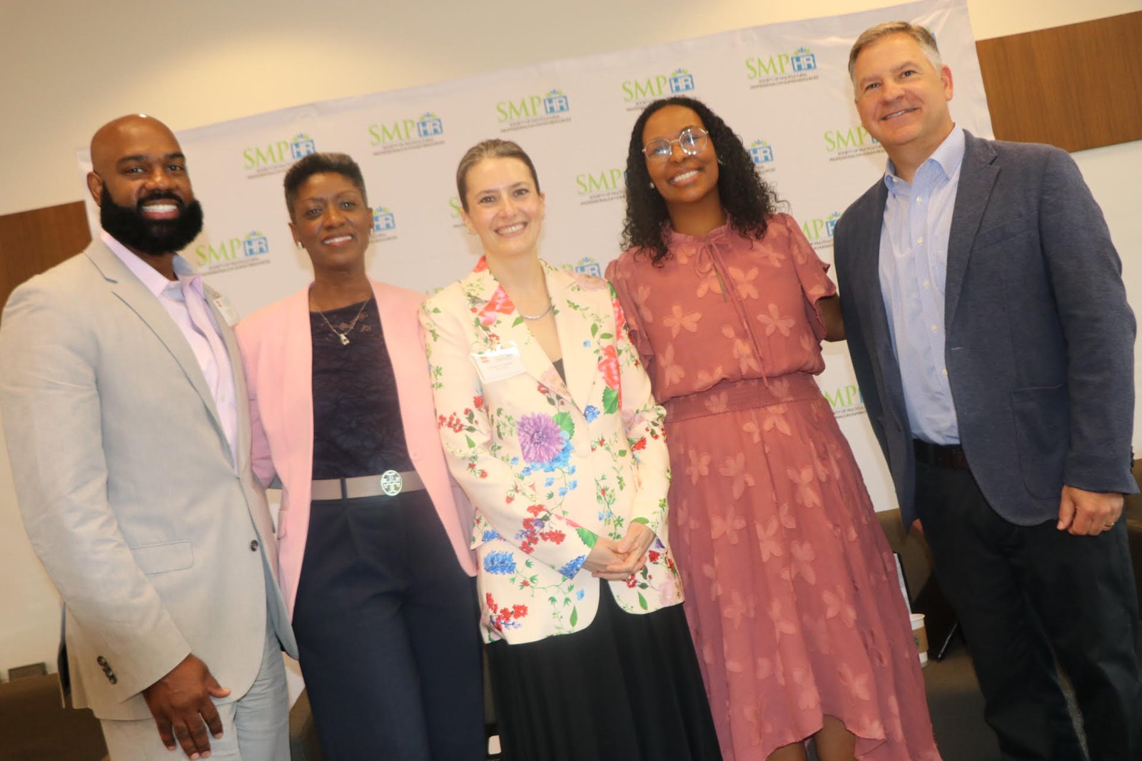 Two women smiling while co-presenting at professional event
