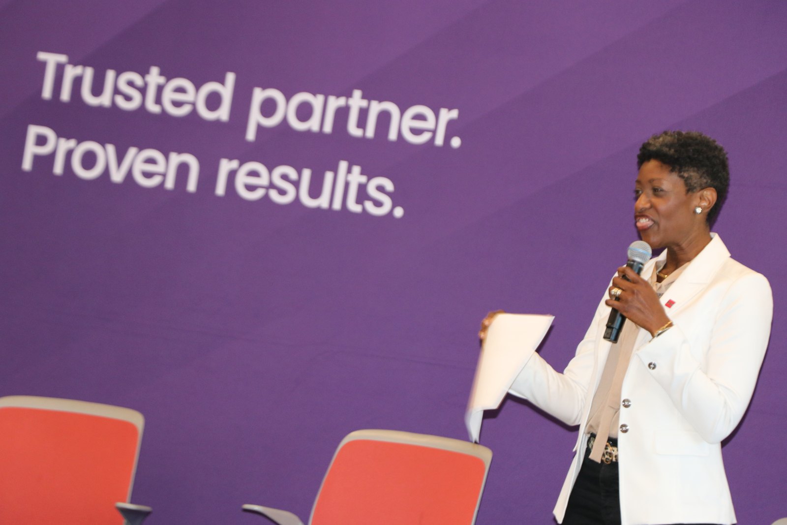 Woman speaker holding document at RGA-branded podium event