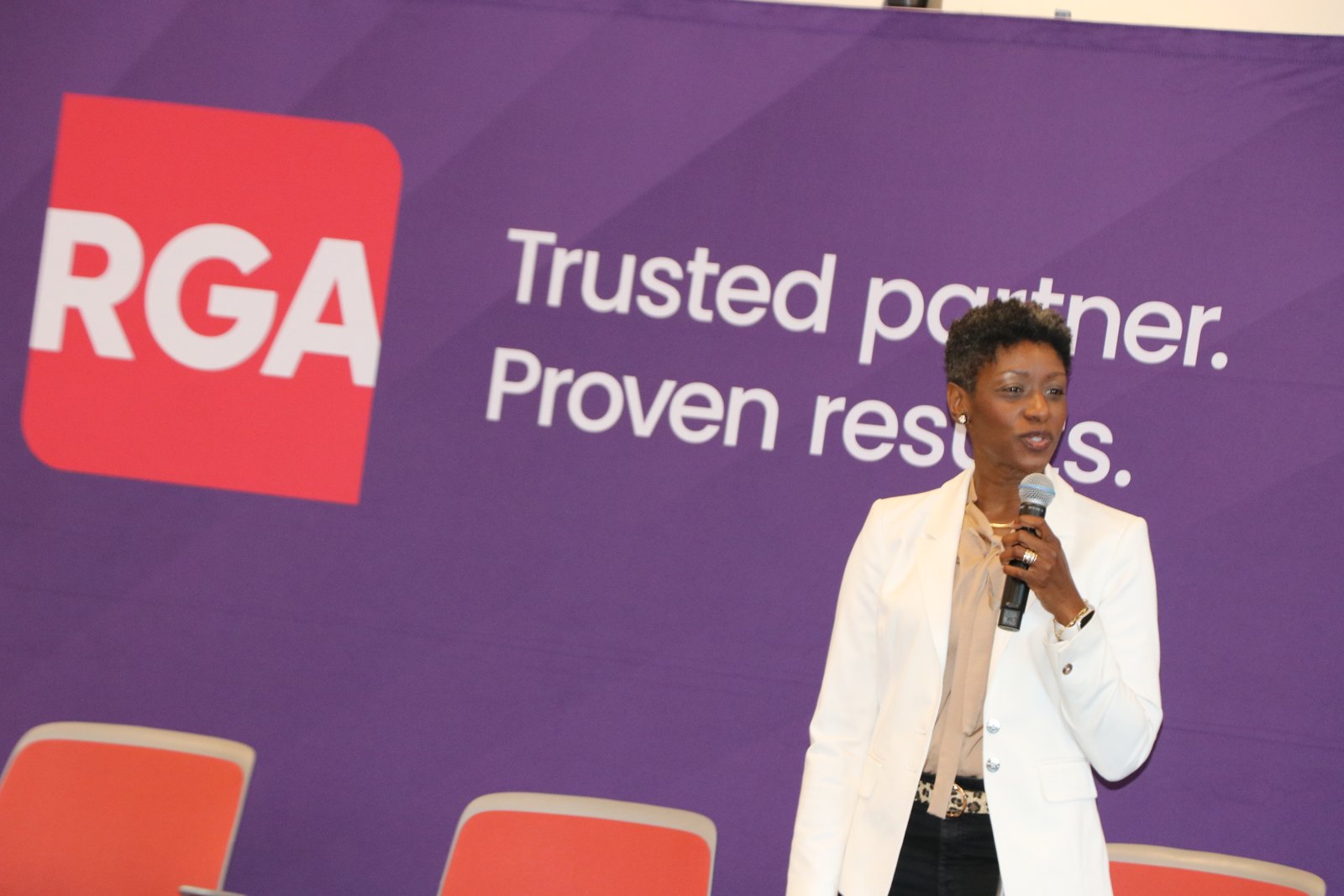 Woman speaking at RGA-branded professional panel presentation
