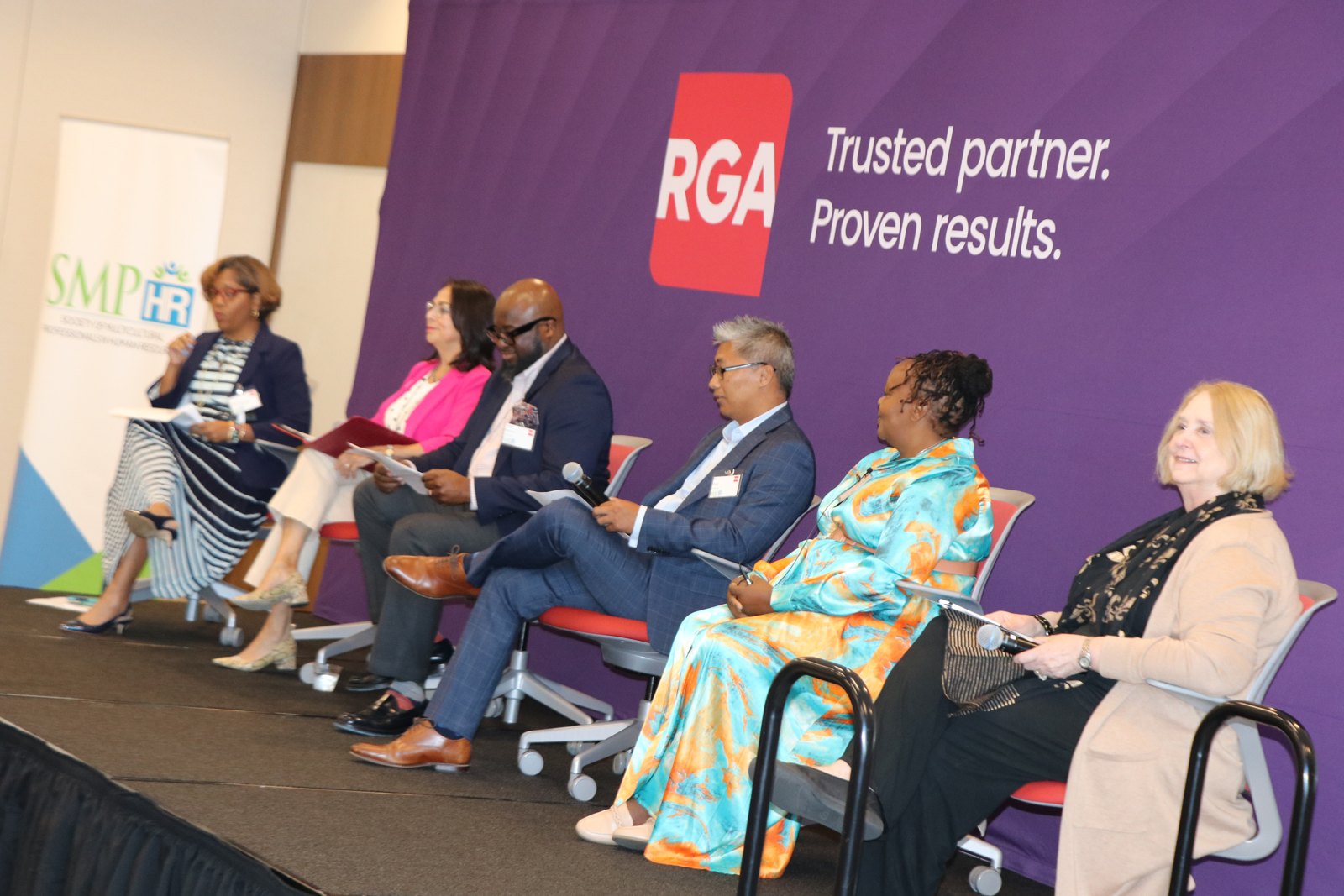 Six HR professionals in panel discussion against RGA backdrop