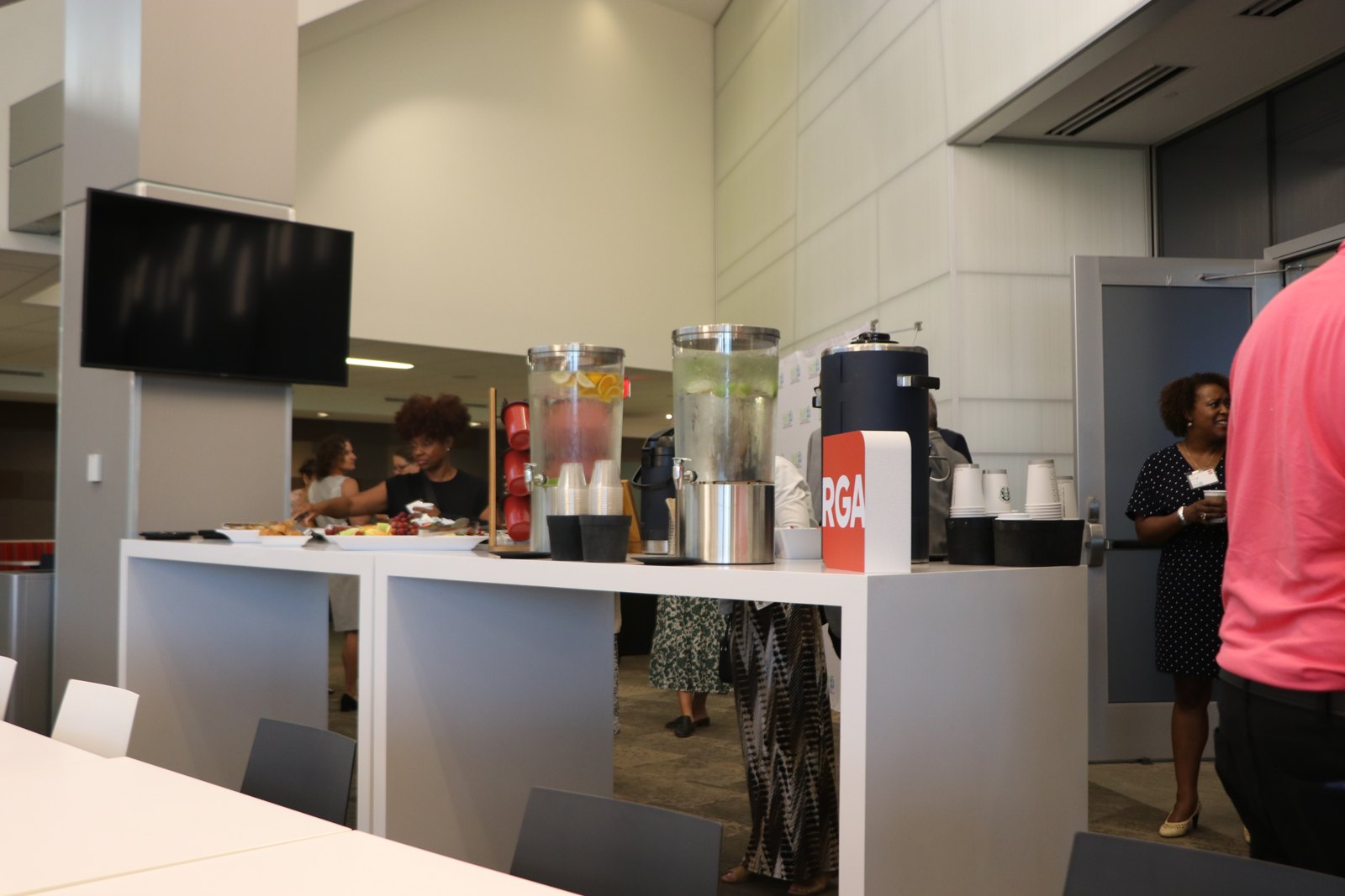 Professionals networking and conversing at indoor event