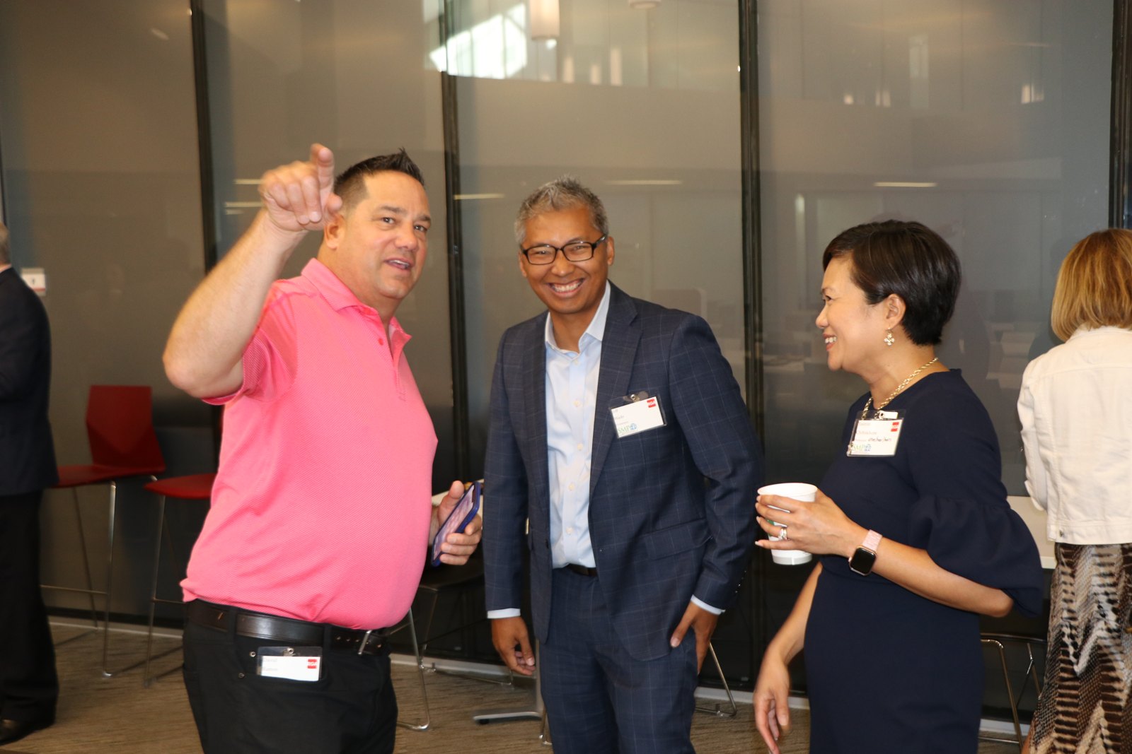 Four professionals conversing at a networking event
