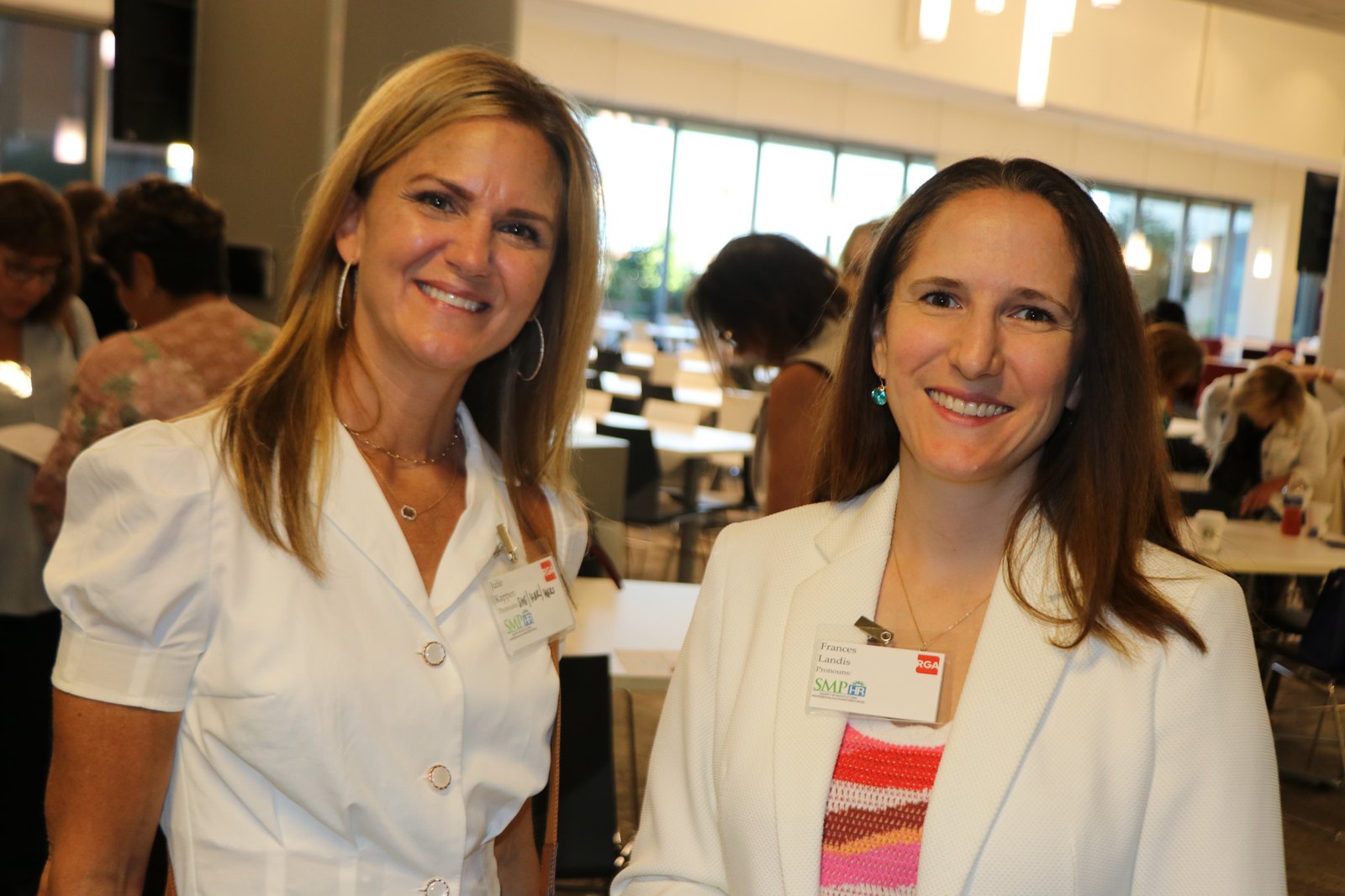 Two women in white blazers at SMPHR networking event