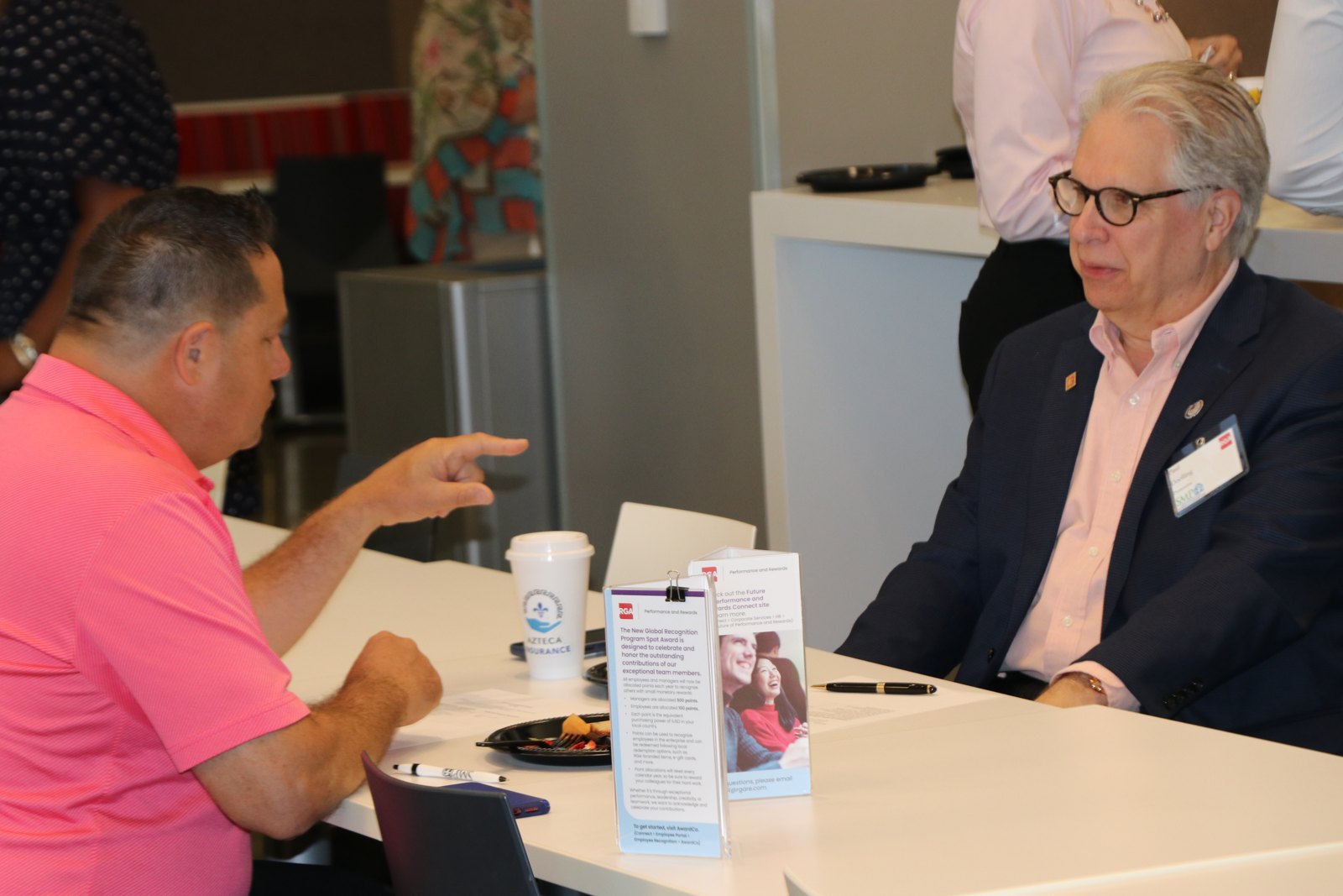 Two professionals in conversation at SMPHR event table