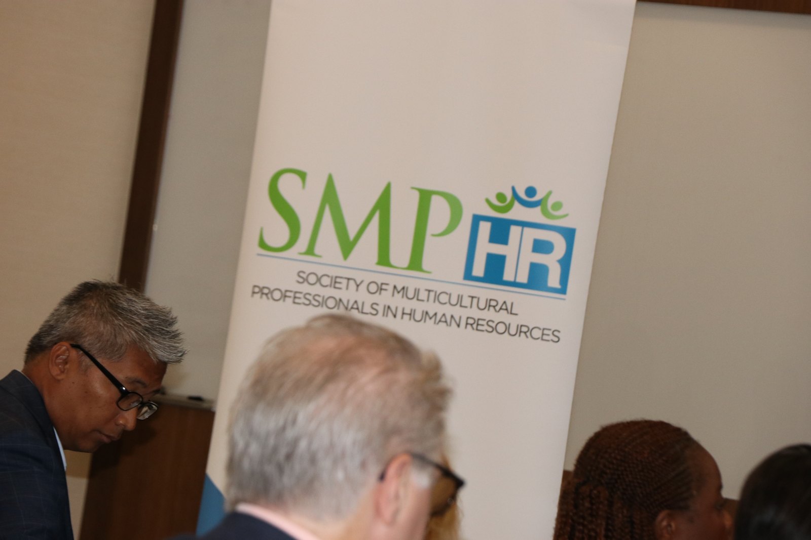 SMPHR banner with professional attendees at event