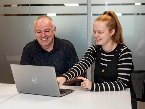 Two colleagues working together on a laptop