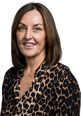 Smiling woman with shoulder-length brown hair wearing a leopard print blouse against a white background.