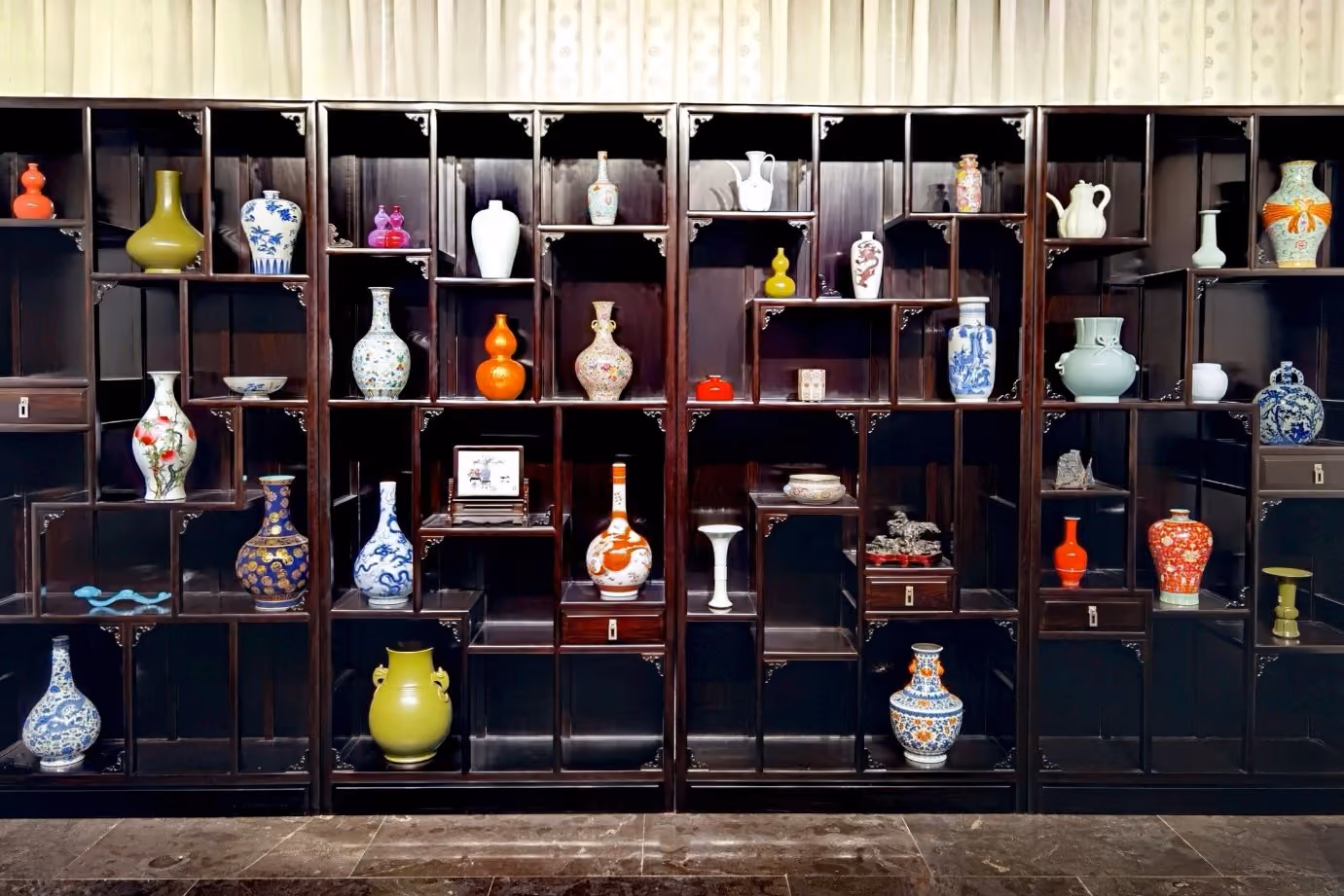 Contemporary fine decorative porcelain displayed in a dobaoge cabinet