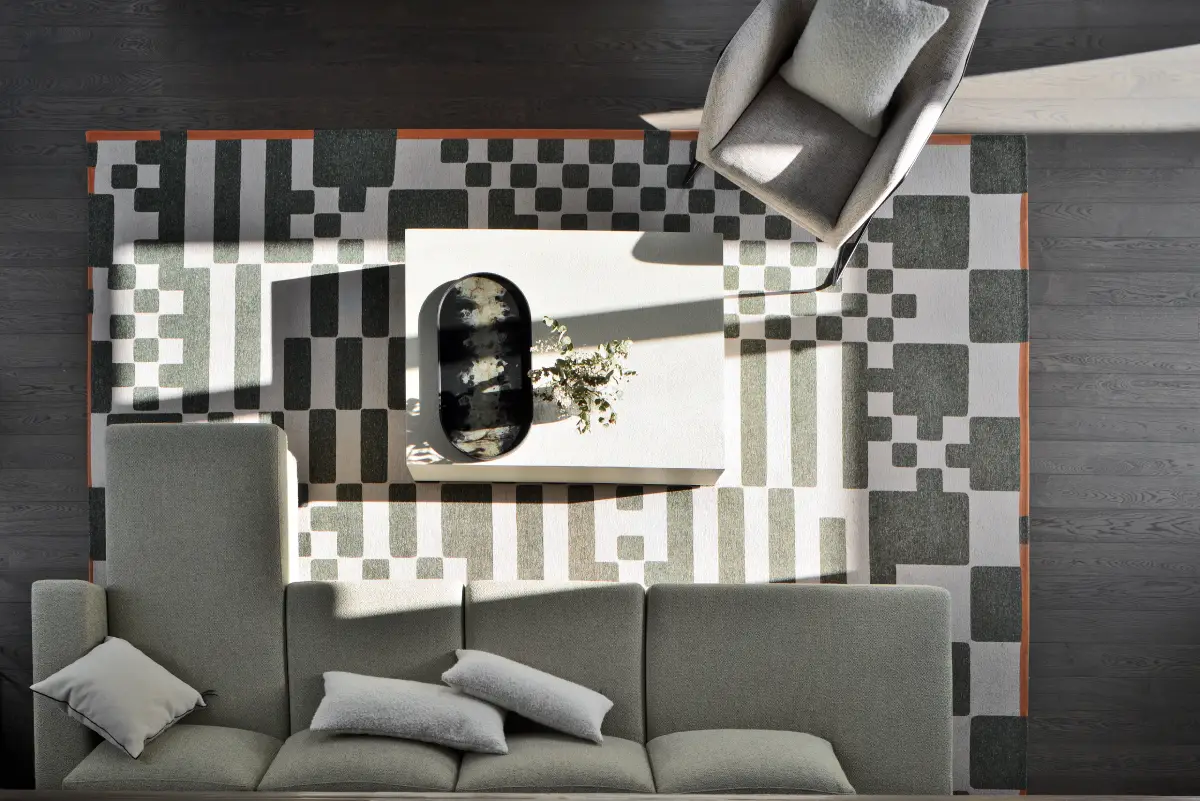 Image d'illustration pour le service mobilier et décoration qui représente un salon moderne et graphique dans les tons gris, avec une prise de vue du dessus