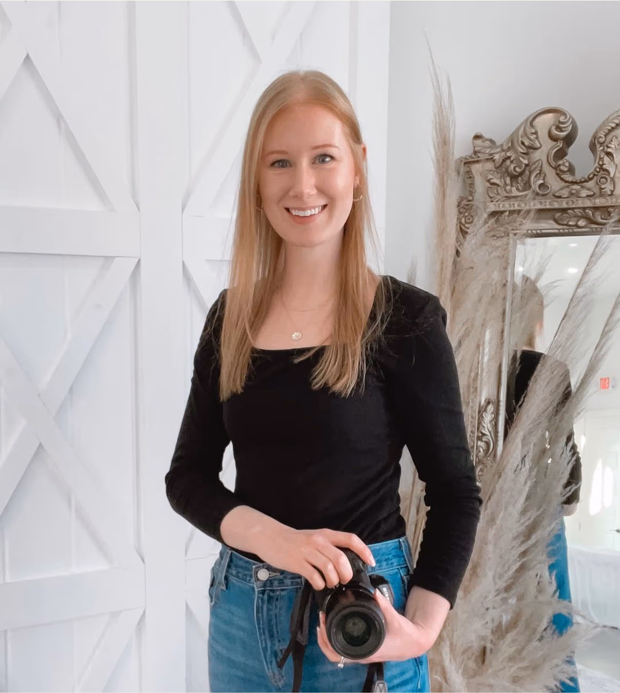 Woman standing indoors and smiling at the camera