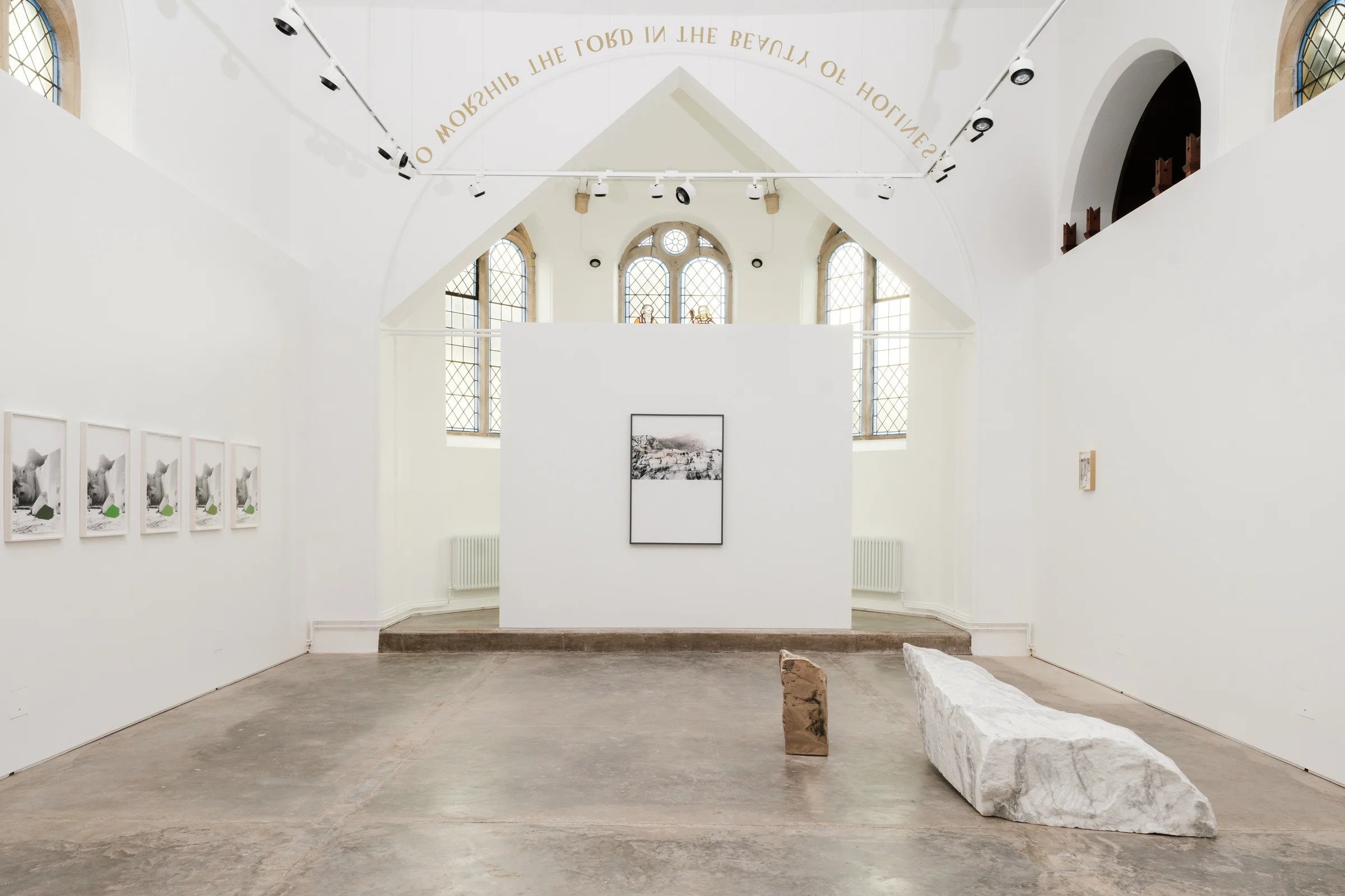 Amy Stephens, Persistence of Land — installation view in a converted chapel, marble block and bronze form on the concrete floor