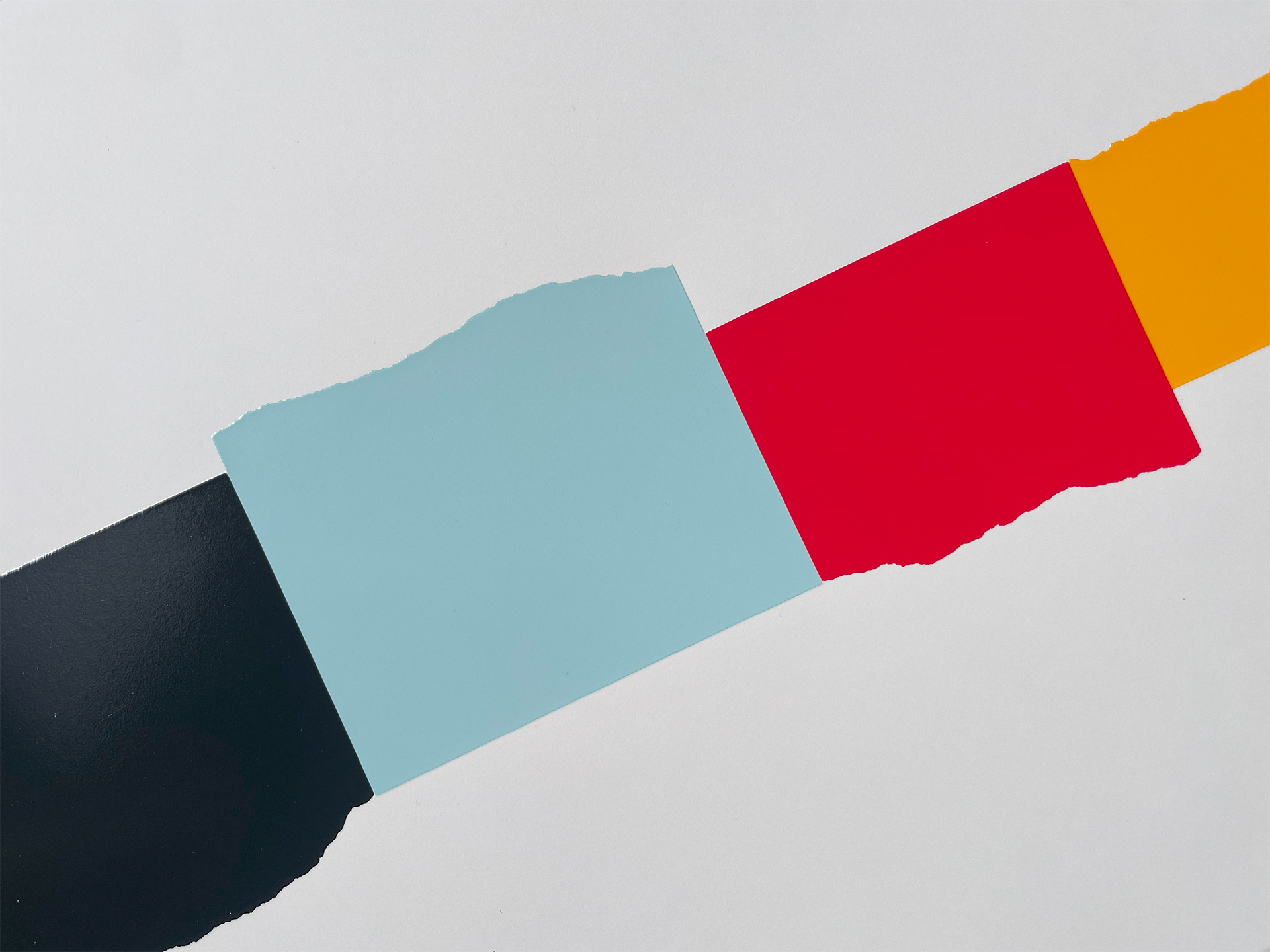 Detail of David Batchelor's Chromoscreen 2 — black, pale blue, red and yellow blocks in a diagonal band.