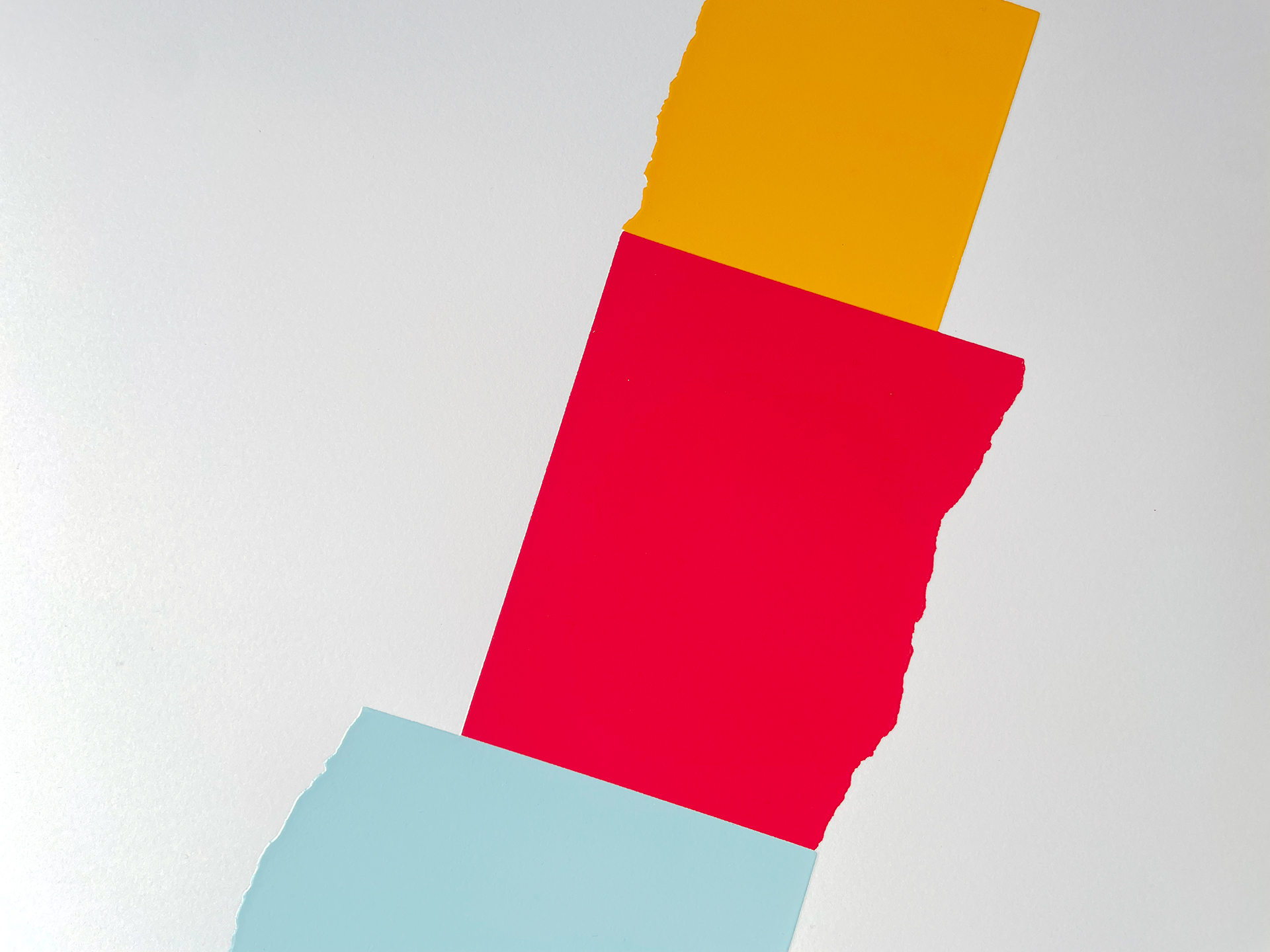 Detail of David Batchelor's Chromoscreen 2 — yellow, red and pale blue blocks meeting at torn edges, shot at an angle.