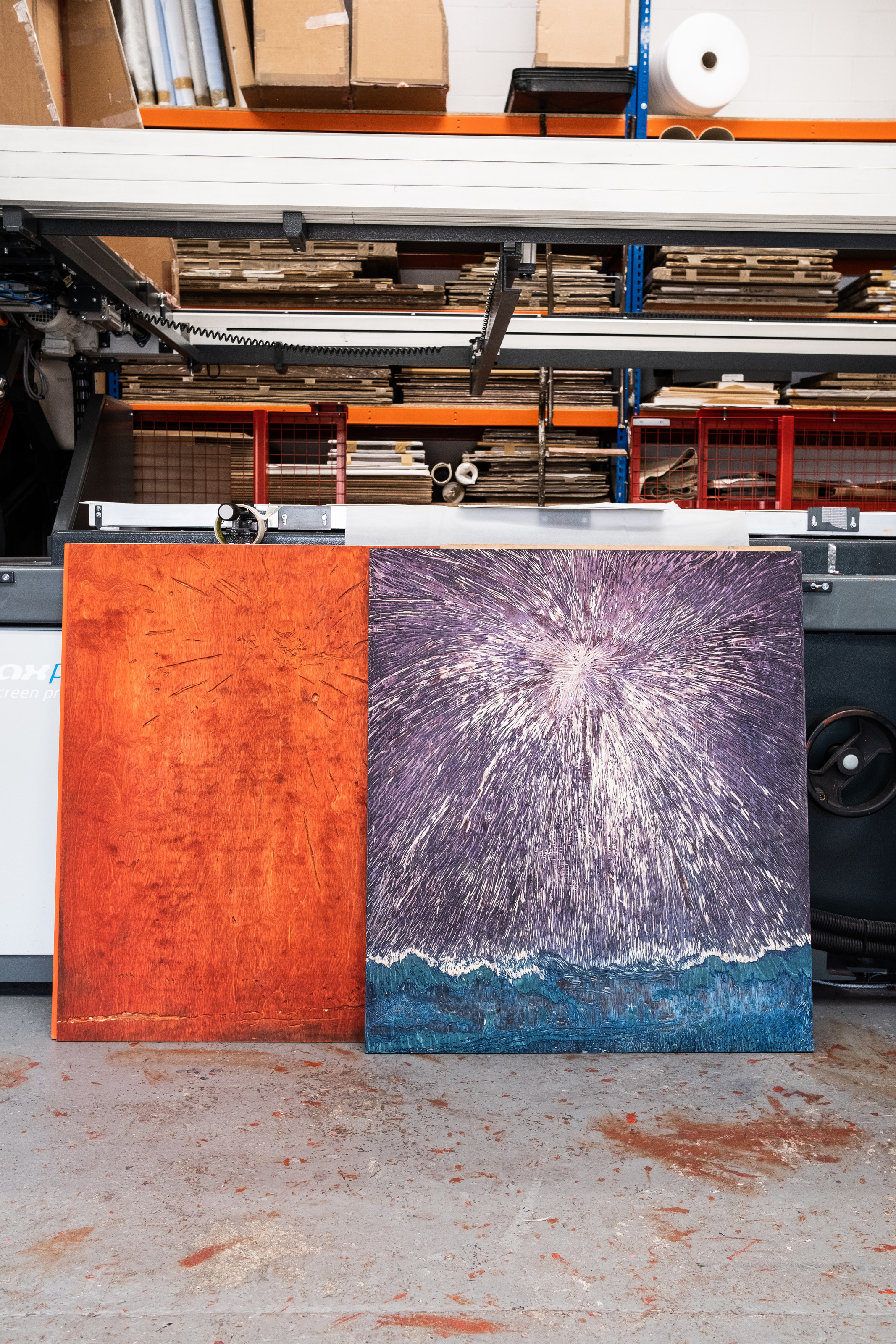 Two carved woodblocks for Jules de Balincourt's edition lean against a press at Atelier JI, the firework design cut into their surfaces.