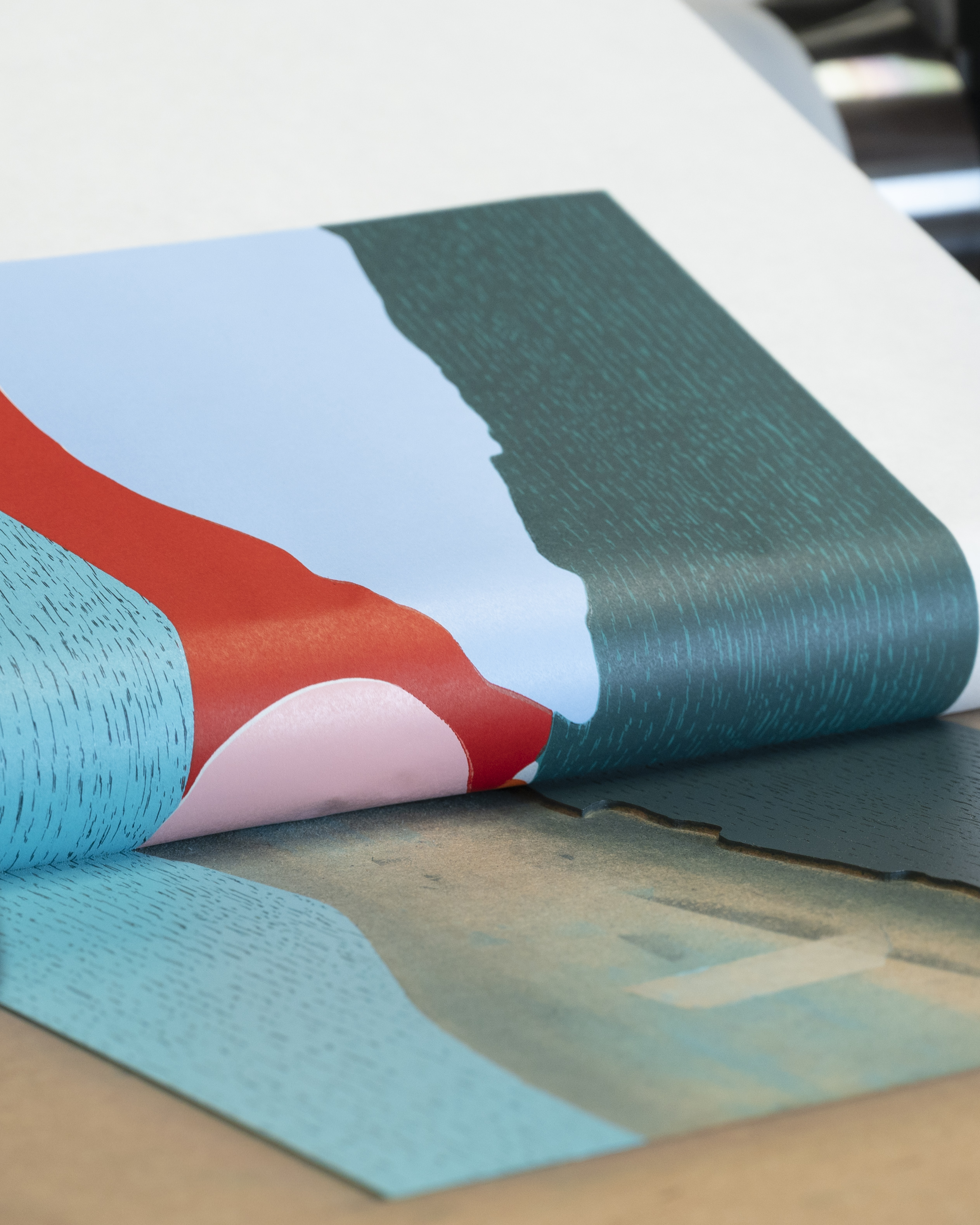Afterglow woodcut on the press, its blue, red and green colour-fields printed on torn-edge Kozo paper.