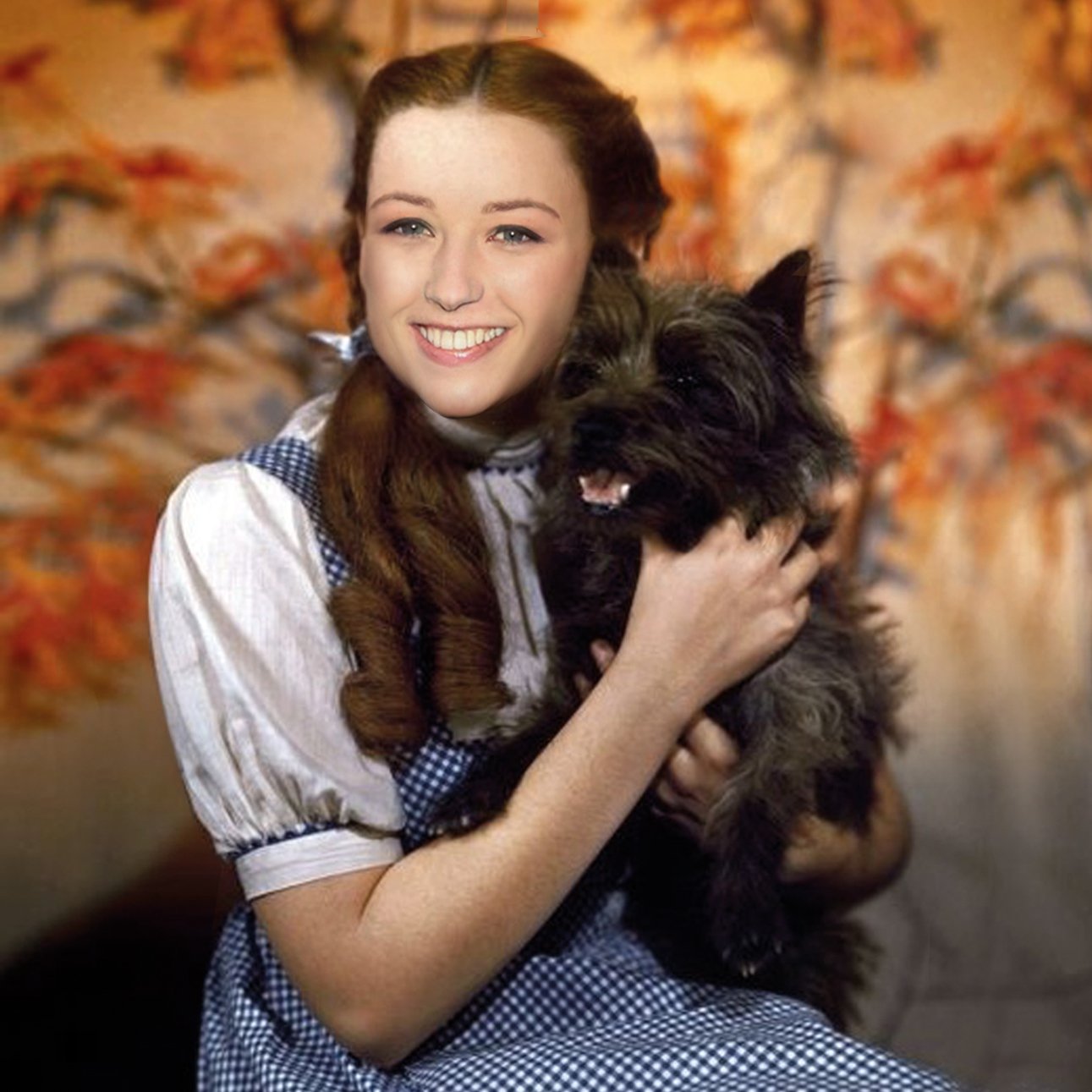 Mychael Barratt, Cindy Sherman's Dog: a young woman as Dorothy from The Wizard of Oz, in gingham, cradling a black terrier.