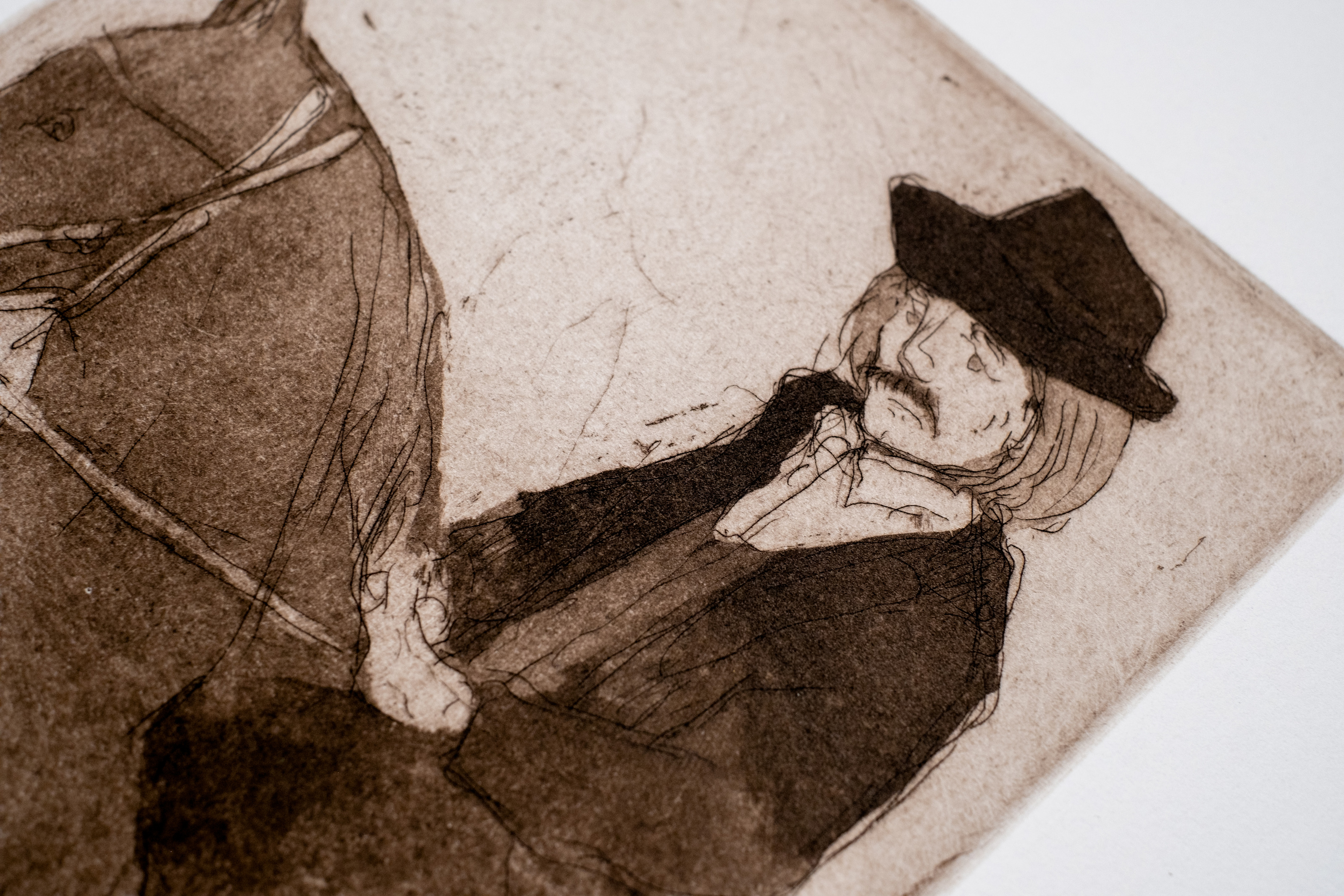 Liorah Tchiprout, The ridge rider (detail): the rider's moustached face under a black wide-brimmed hat.