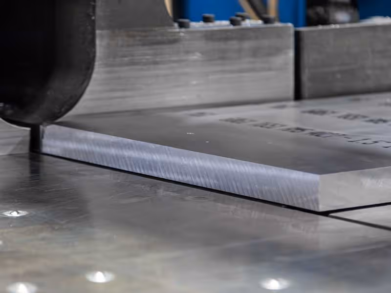 Precision aluminum plate sawing operation showing close-tolerance cutting of aluminum plate material at ICI Metals.