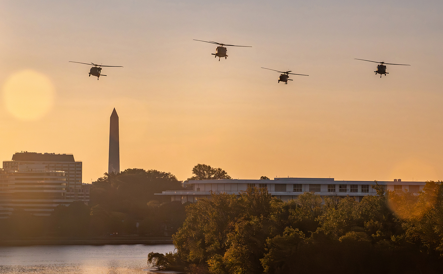 Military helicopters flying over Washington, DC at sunrise