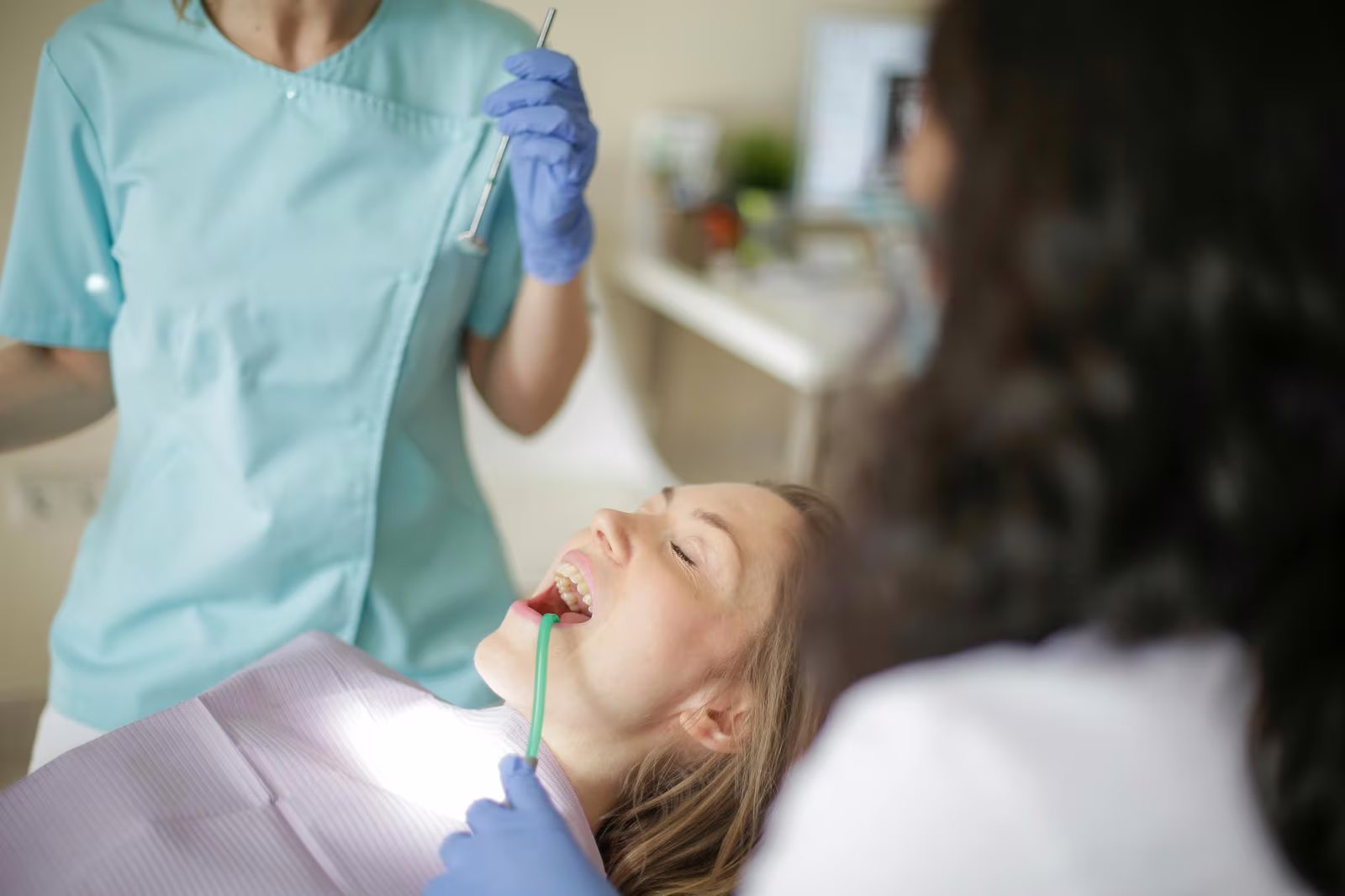 Dentist evaluating a patient for same-day implant placement after extraction at Sola Dental Spa