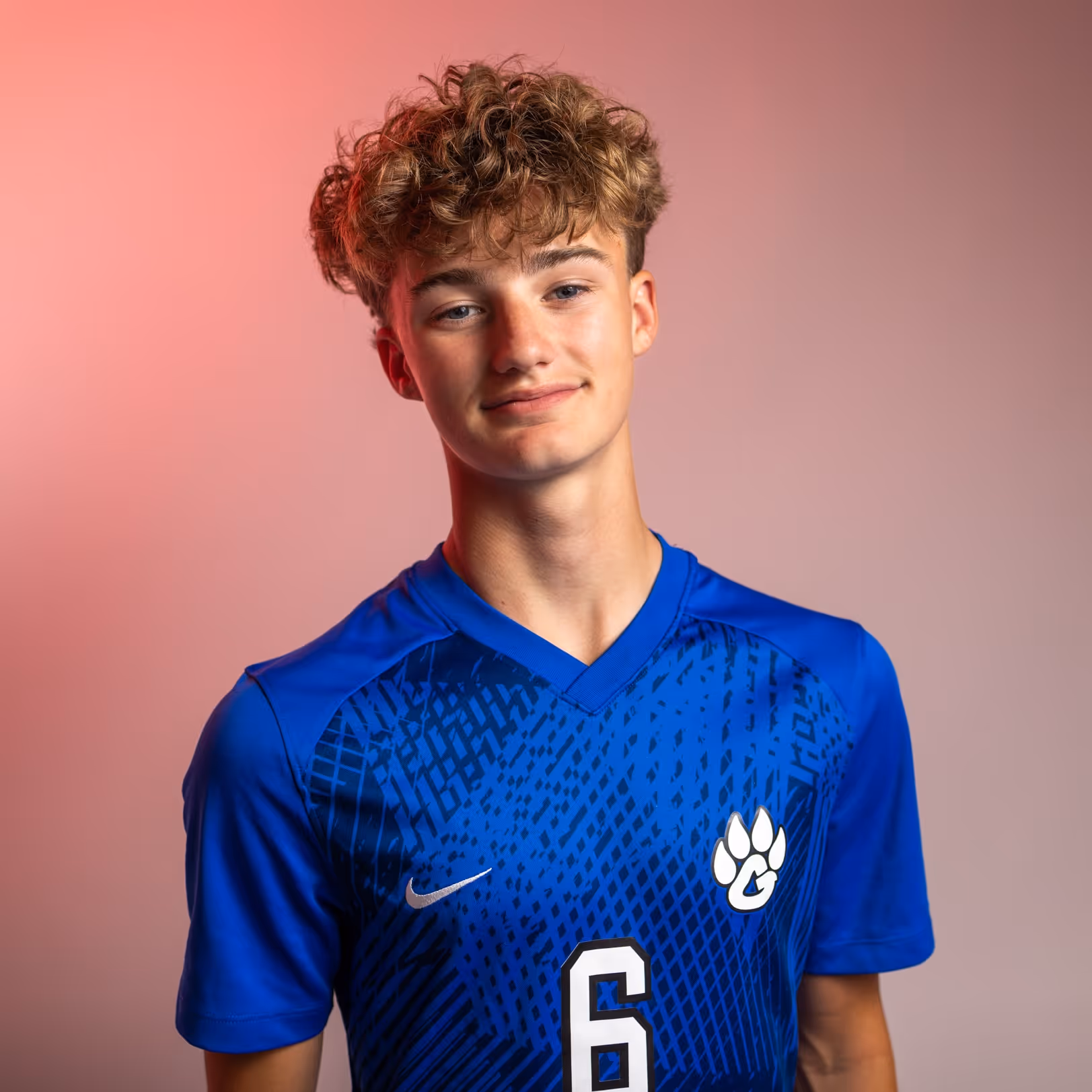 Weston Ochs in blue sports jersey with number 6 and white paw logo.