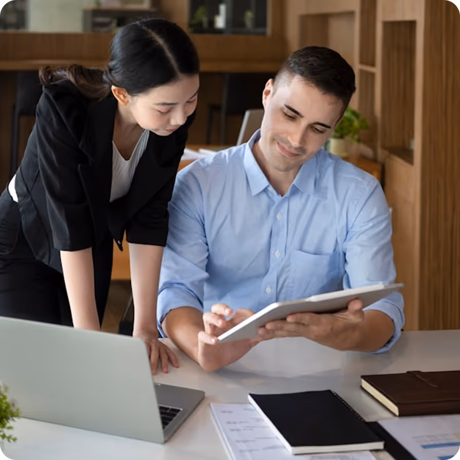 Consultant and client reviewing data on a tablet in a professional office setting