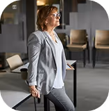 Professional woman presenting with a laptop in a business meeting setting
