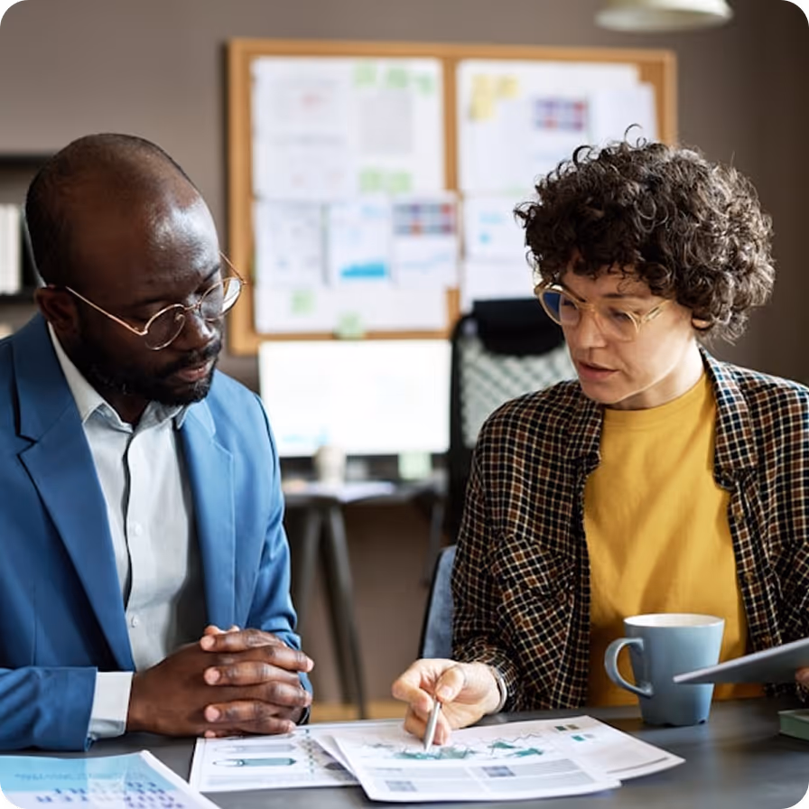Consultant and client reviewing data on a tablet in a professional office setting