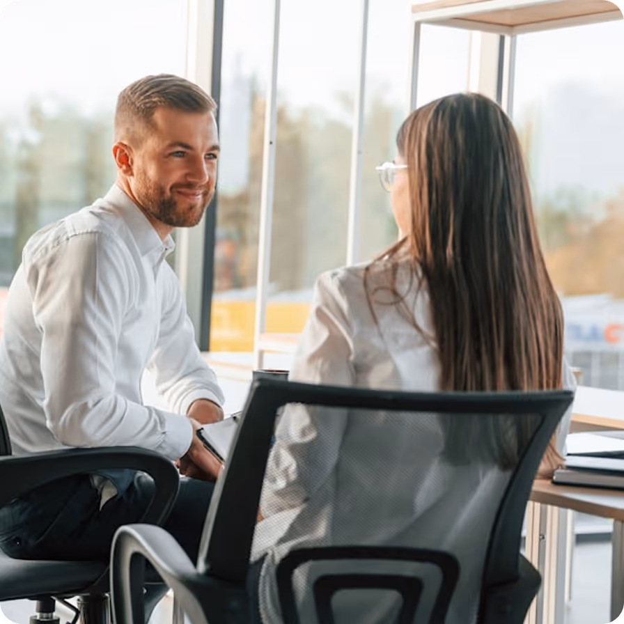 Consultant and client reviewing data on a tablet in a professional office setting