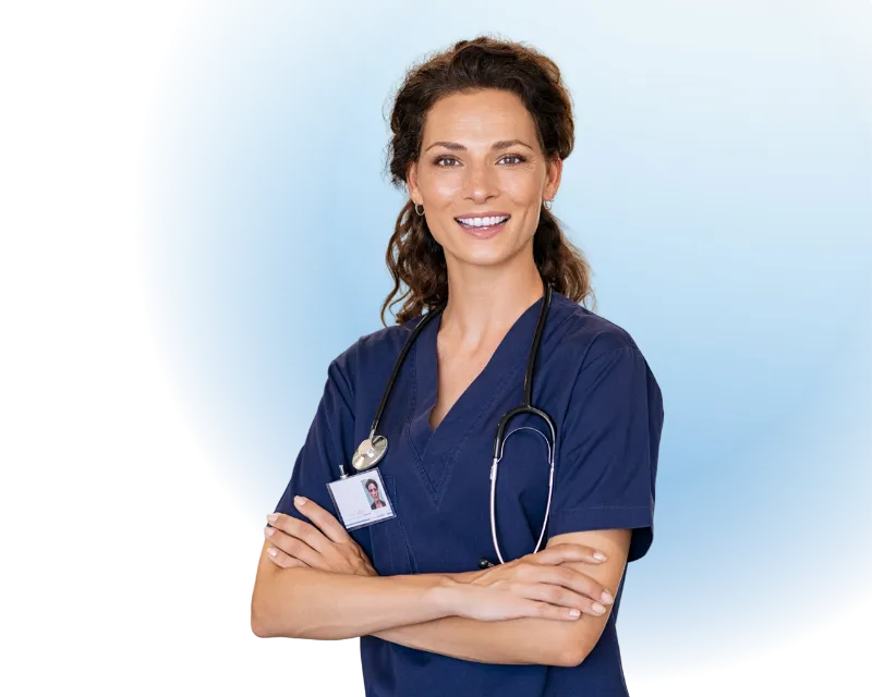 Smiling female nurse with curly hair wearing navy scrubs and a stethoscope around her neck.