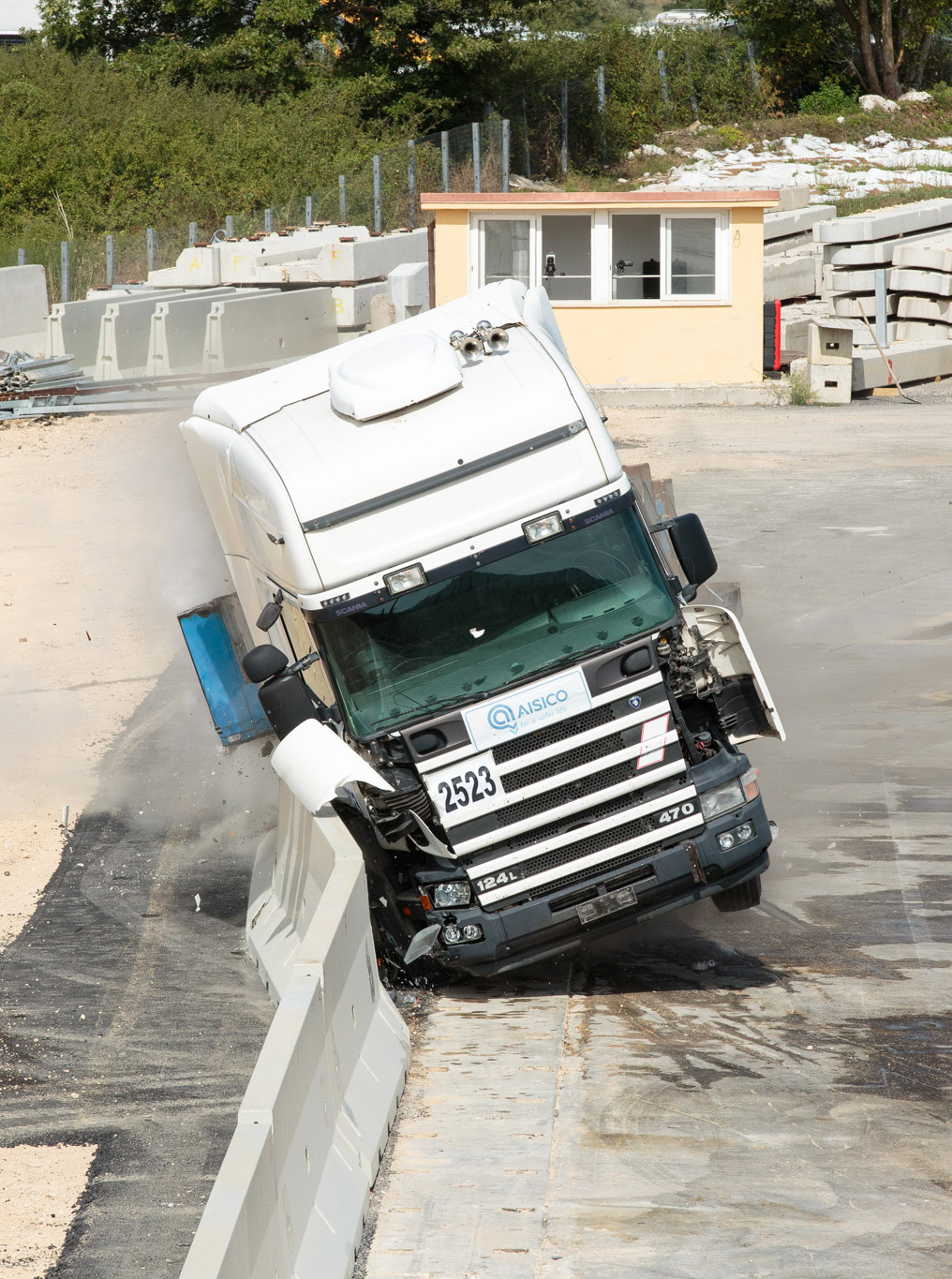 Camion inclinato dopo l'impatto contro una barriera in calcestruzzo durante un crash test